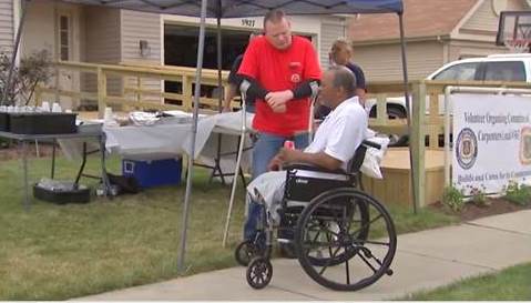 Disabled man viewing new home being built