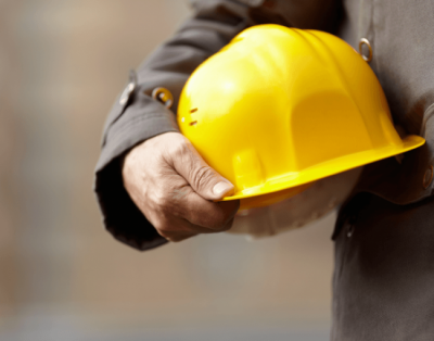 Construction worker holding hardhat