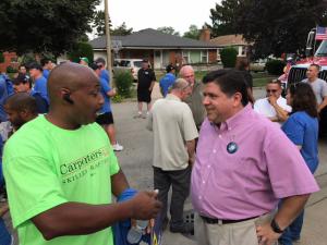 Carpenters speaking to Pritzker at parade