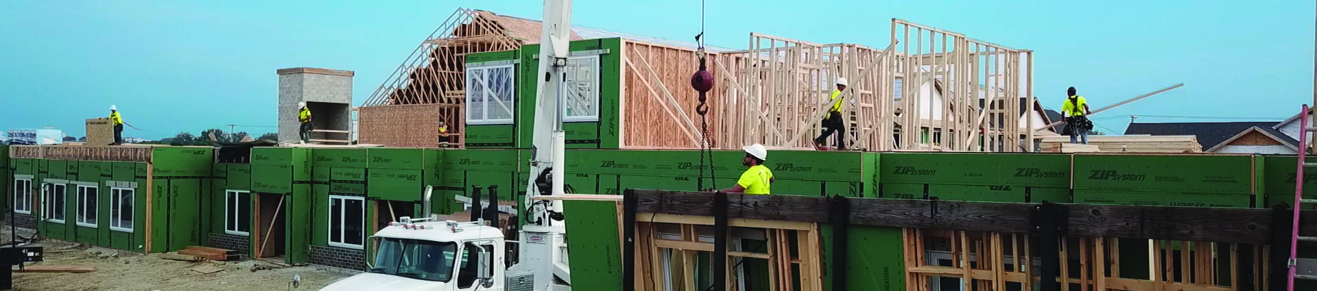 Construction workers lifting materials with a crane