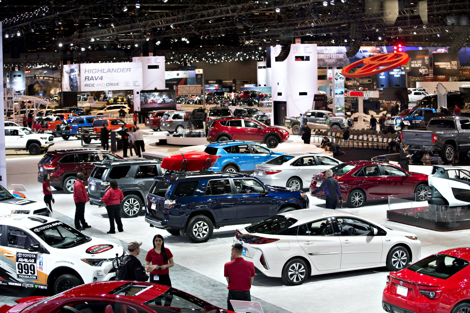 Vehicles sit on display in the Toyota booth, foreground, during the Chicago Auto Show in Chicago, Illinois, U.S., on Thursday, February 9, 2017. Photographer: Daniel Acker/Bloomberg