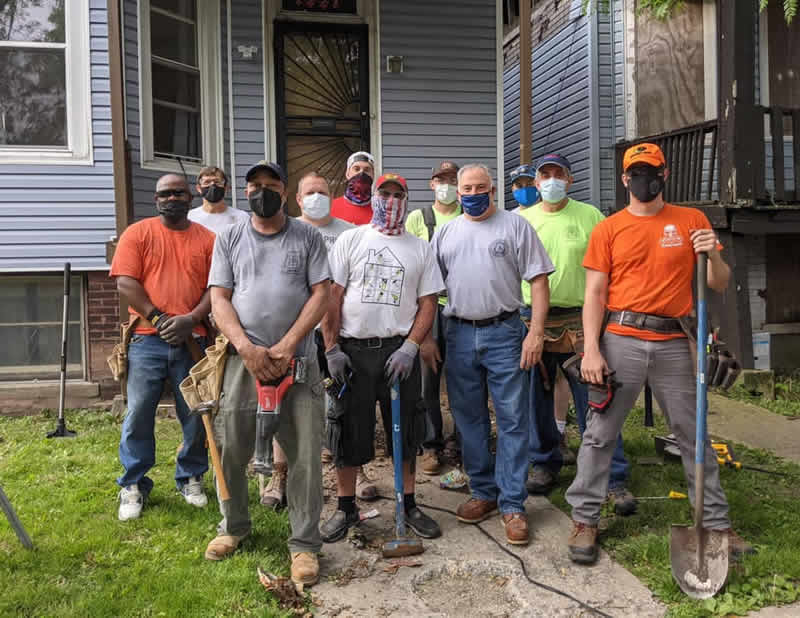 Carpenters volunteering for 100 Days of Service Project pose together