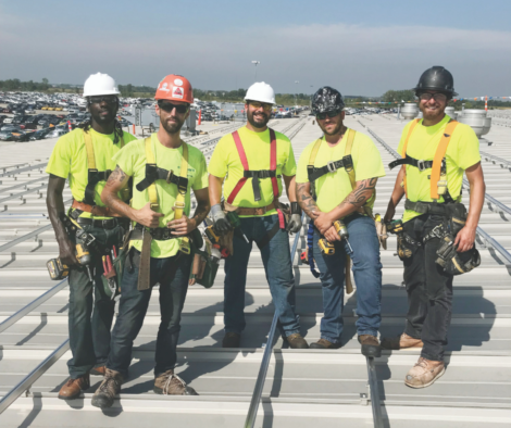 Crew installing solar panels on roof