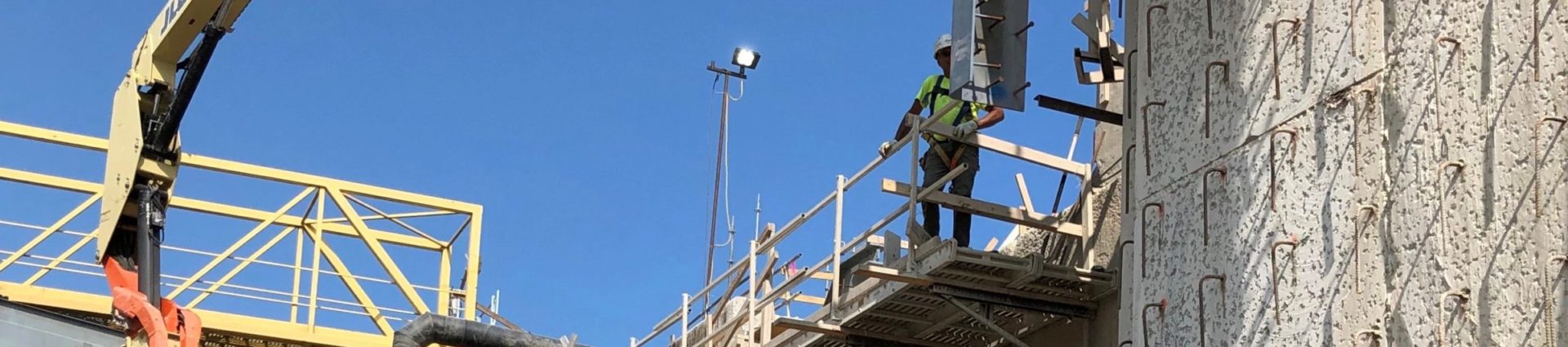 A worker on top of a large lift