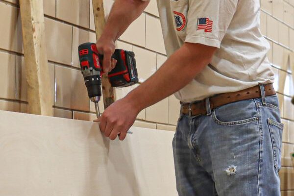 Image for St. Louis Carpenters Install Doors At Dismayed High School